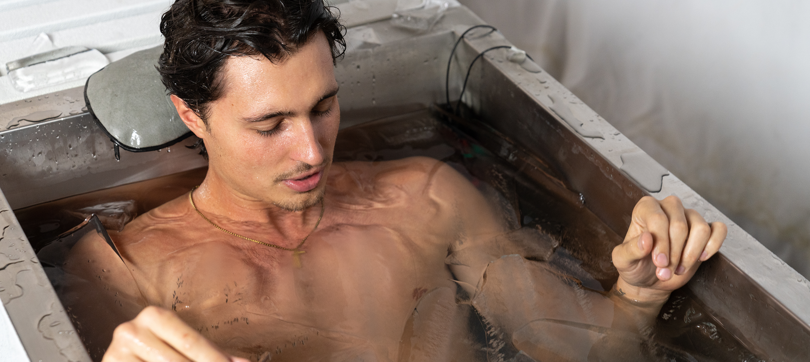 a man laying in a Morozko Forge cold bath